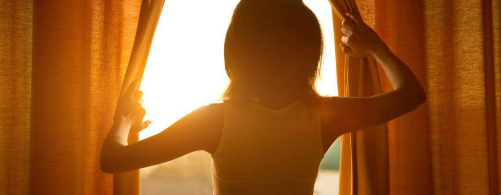 8-NSF-3-L_Woman-parting-curtain-over-balcony-in-the-morning_2880x1400[1]